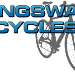A welcoming central Cambridge bike shop displaying a variety of Tern cargo electric bikes, Ridgeback hybrid commuter bikes, and a professional bicycle repair workshop station.